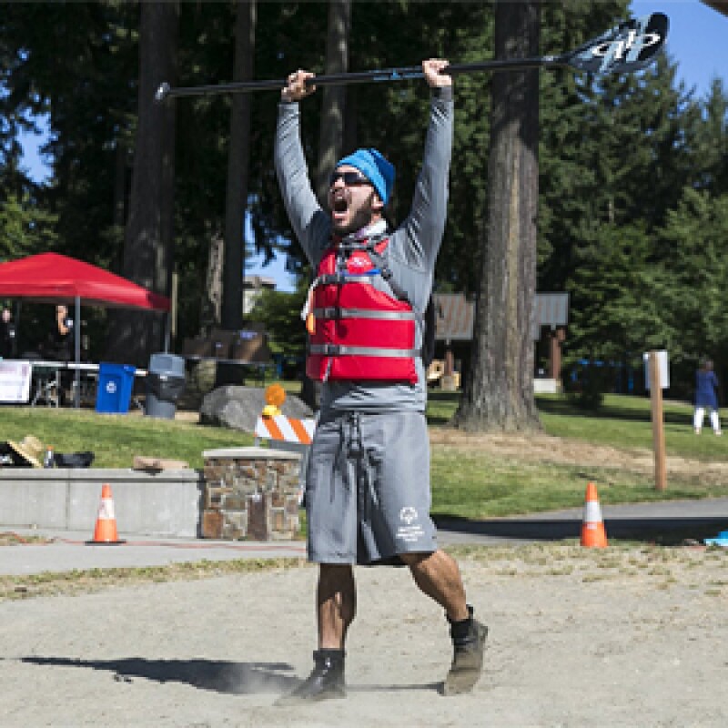 Danny Fundora cheering and holding an ore above his head.