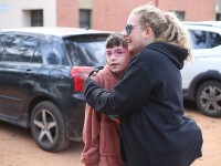 Woman hugging a younger girl.