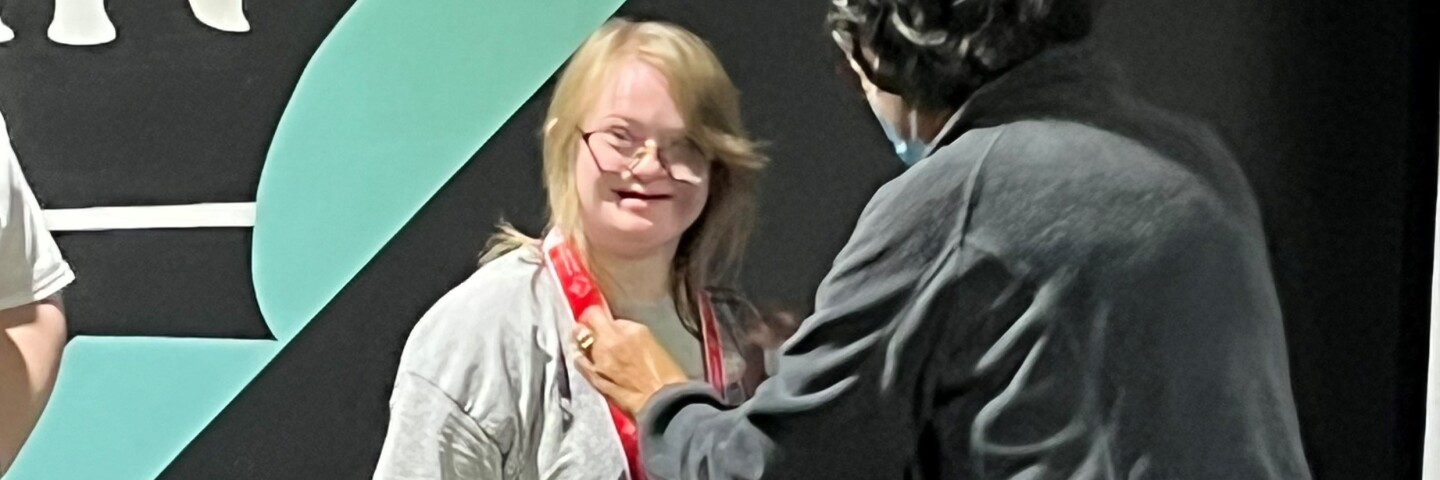 Elliott Sten receives her medal for bowling