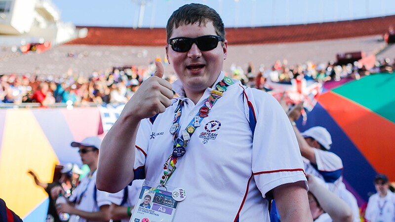 Athlete giving a thumbs up at a games event.