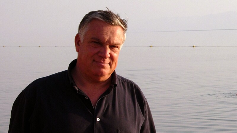 Dr. Benedetto Saraceno with his head resting on his had looking off into the distance. 