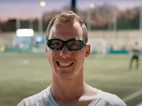 Man in athletic glasses smiling. 