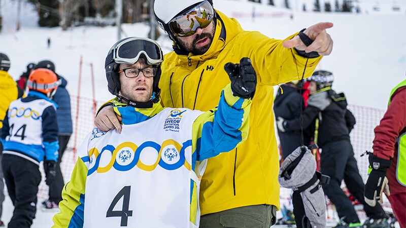 Coach and athlete assessing what is to come down the track.