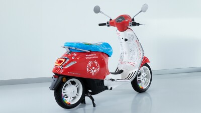 red vespa cycle with blue seat
