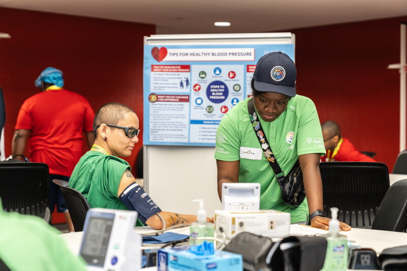 Athlete having blood pressure taken by a health care worker. 