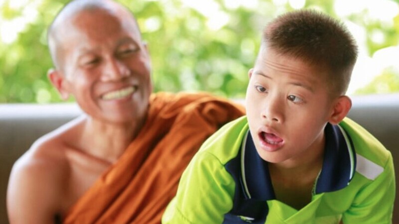 Young man sitting with a monk. 