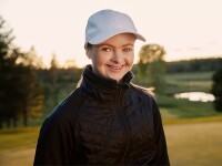 Special Olympics Finland golfer Wivan Atrila smiles to the camera