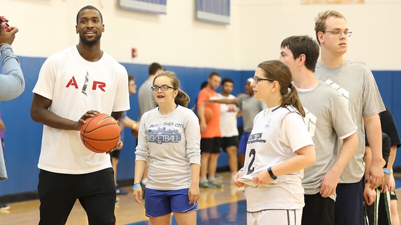Michael Kidd-Gilchrist on the court with unified athletes giving them a lesson.