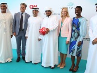 A group of people standing in front of signage.