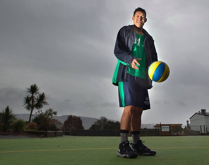 Ruaumoko Pukepuke bouncing a basketball on a court. 