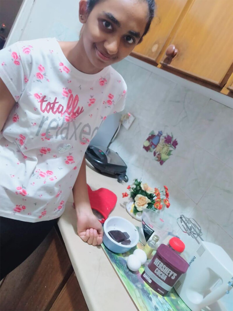 Youth Leader in the kitchen with ingredients on counter top.