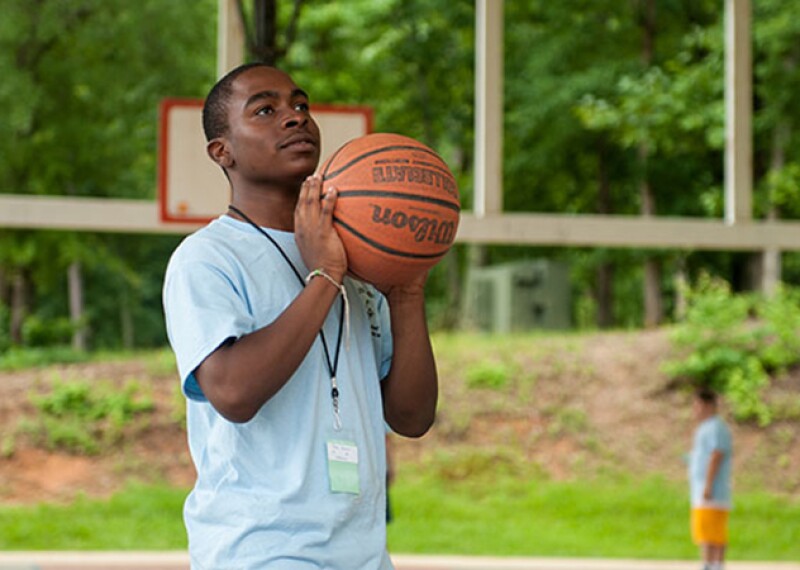 An athlete practices their basketball skills.