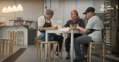 Three employees working together at a table