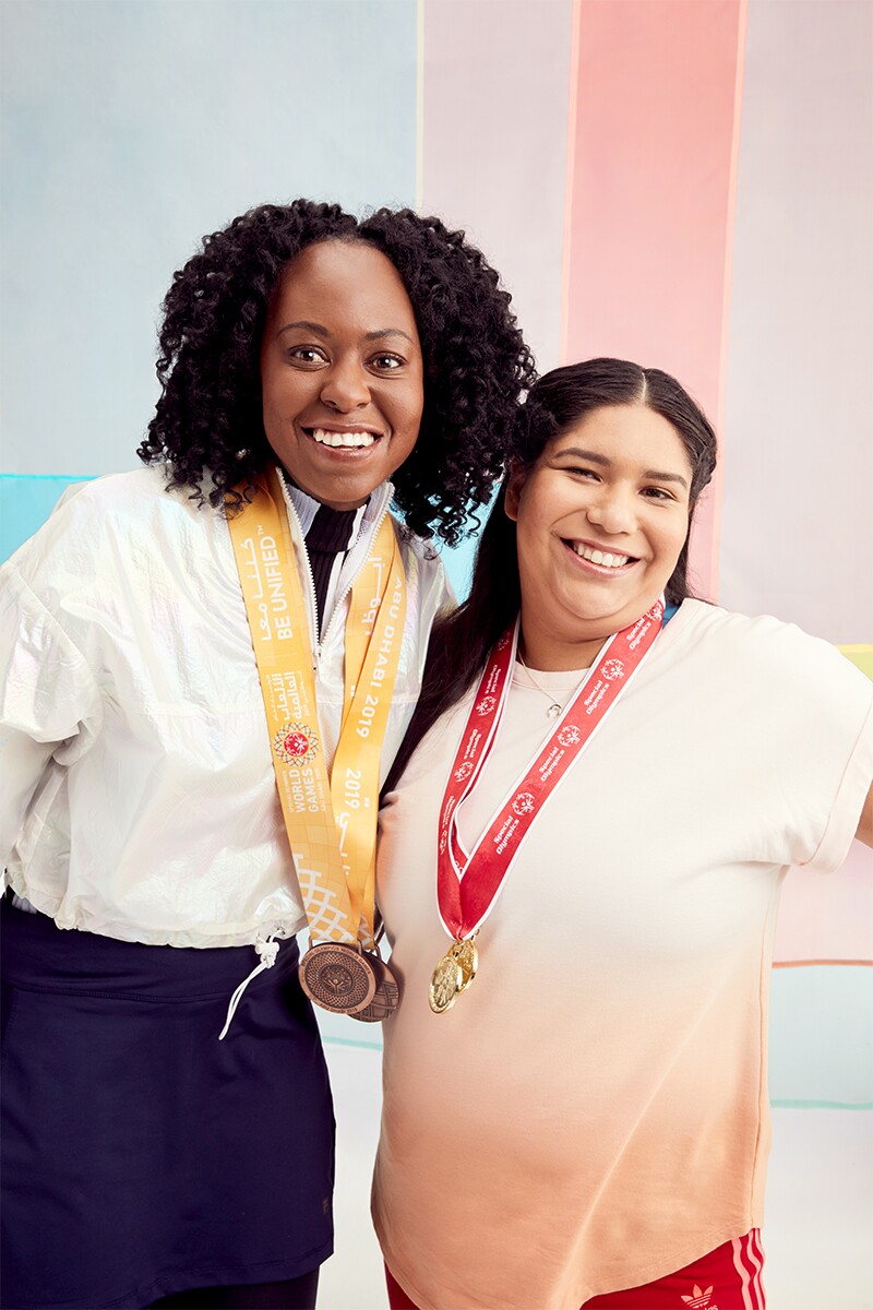 Special Olympics Southern California athletes Krystal Johnson and Jenna Ramirez with medals hanging around their necks.