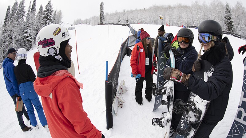 Latrice talking to Hanna Teter and other snowboarders on the slopes.