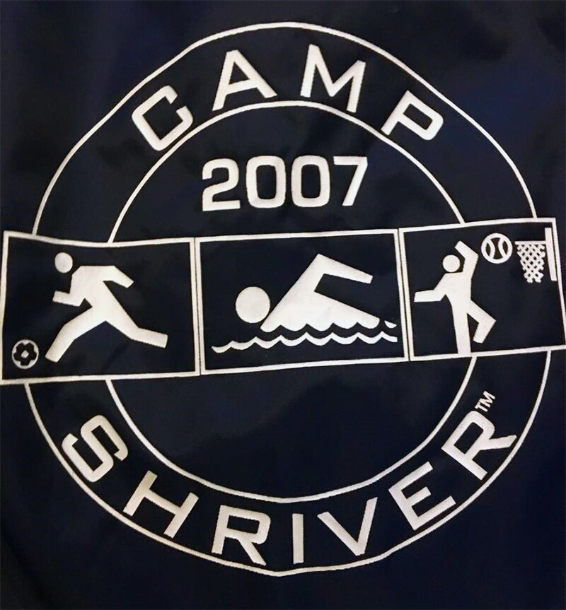 Camp Shriver logo designed by Robert Jones. Black flag with white illustrations and words.