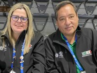 A woman and man sitting side by side. 