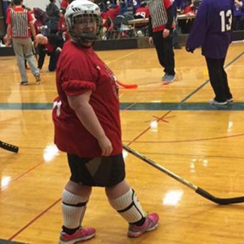 Katye Barton, Special Olympics Minnesota athlete, playing floor hockey. 