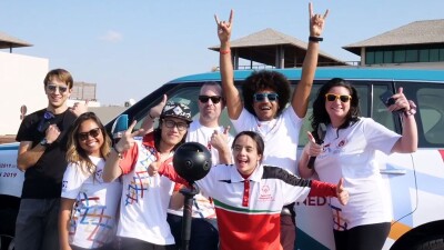 Crew and Athlete pose for a group photo in front of the VR camera