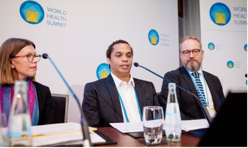 Three individuals sit next to each other during a panel discussion. 