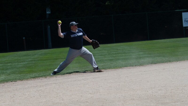 Male softball player preparing to throw the ball.
