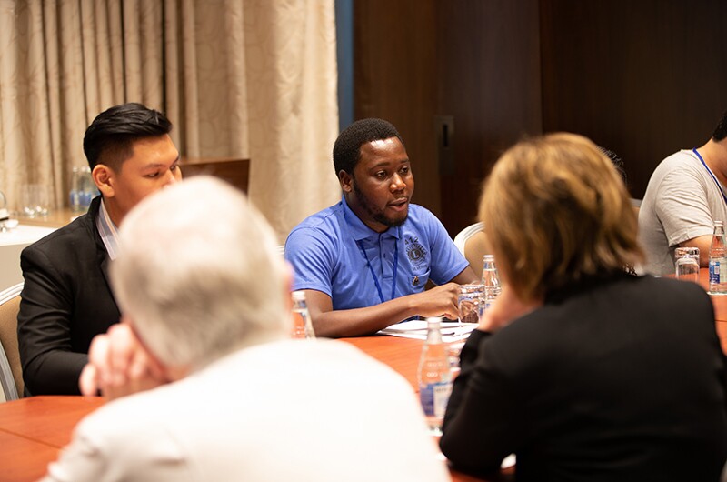 Peter Kanzunguze Jr, a Leo from Blantyre, Malawi in discussion with fellow Leo participants and International President of Lions Clubs International Gudrun Yngvadottir at the Special Olympics Global Youth Leadership Forum. 