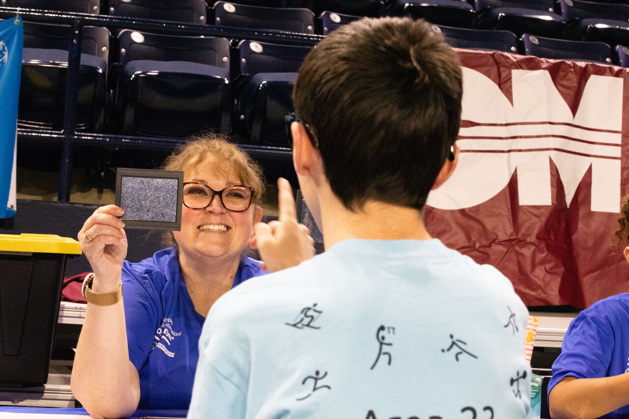 Volunteer smiles during Opening Eyes