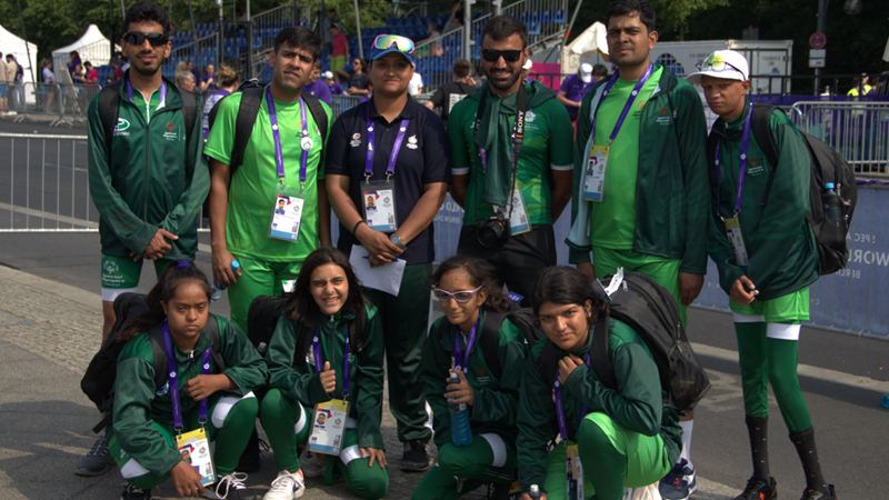 SO Pakistan cyclists and coaches huddle together for photo post competition.