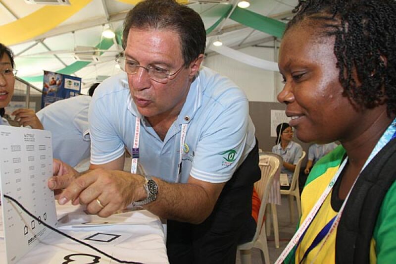 Dr. Paul Berman screening a woman at a screening event.