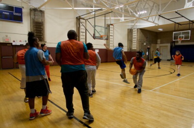 Participants compete in a unified basketball game during an indoor sports program.