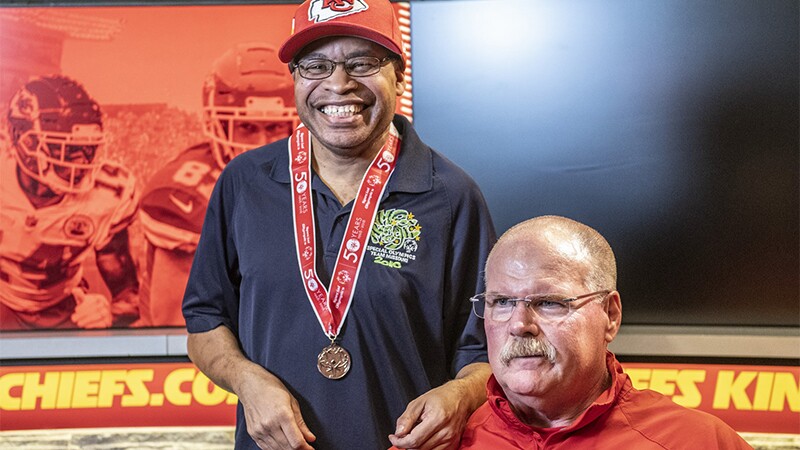 Special Olympics Missouri athlete Arthur Murphy poses with Kansas City Chiefs Head Coach Andy Reid.