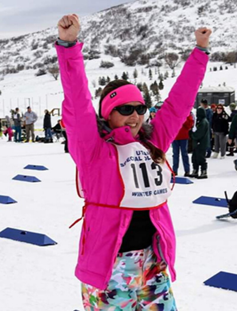 Amber raising her hands in celebration.