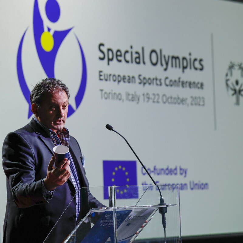 A man standing at a podium and presenting. 