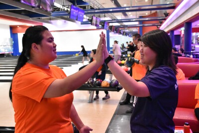 Two athletes celebrating at bowling. 