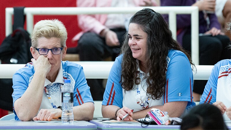 Cindy Schopper sits with another female bowling coach.