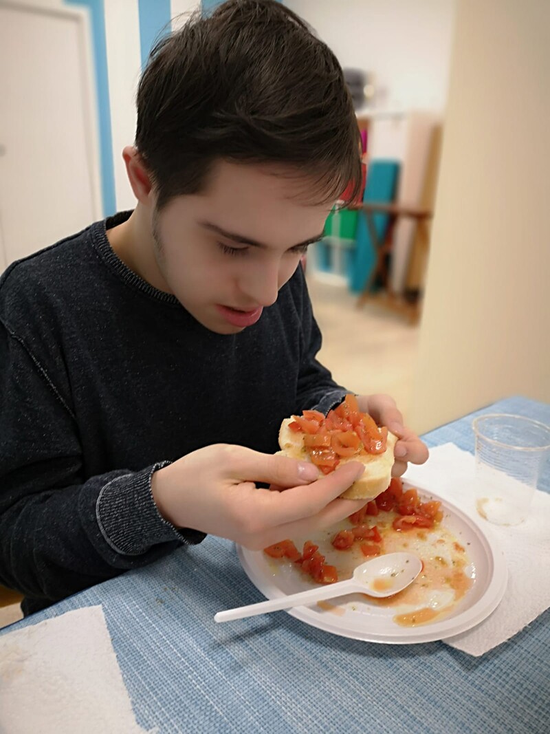 Athlete eating the Italian Tomato Bruschetta he just made.