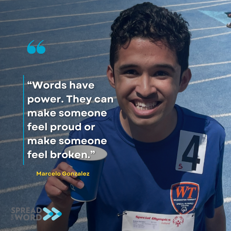 Young man on a track, looking up and smiling. 