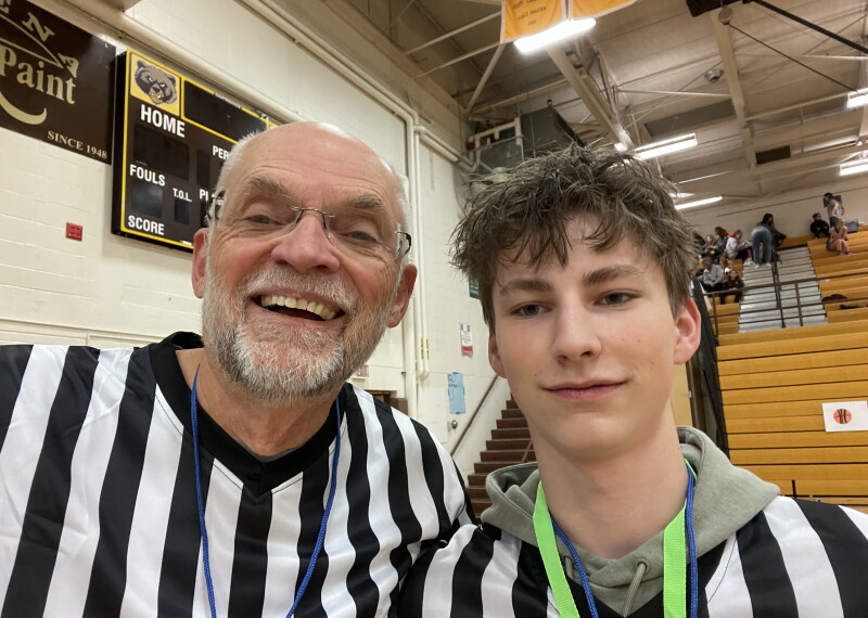 Two referees standing side by side. 