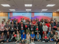 Large group of people standing in rows for a group photo. 