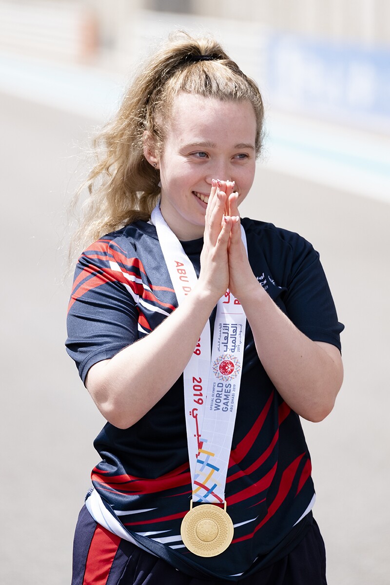 Kiera Byland standing with a gold medal around her neck.
