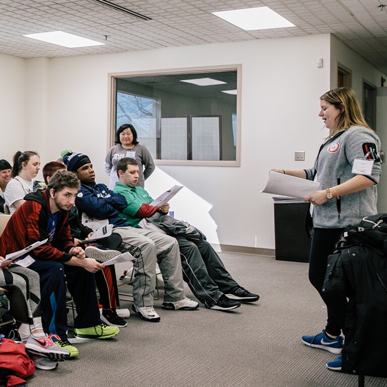 Speaker speaking to a room of people.