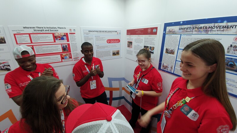 Six people in a room conversing. 