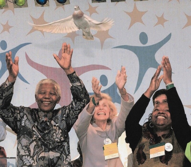 Three people with their hands up