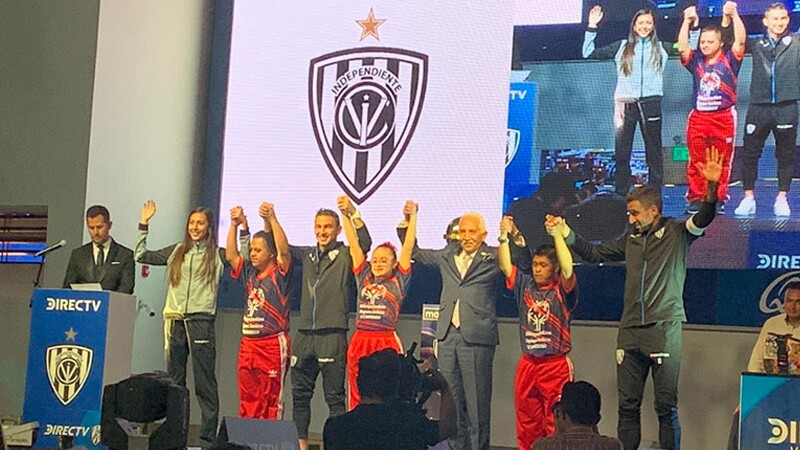 Special Olympics athletes and representatives along with professional players on stage together.