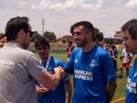 Special Olympics Madrid football player Rubén Reales smiles while shaking hands with another man