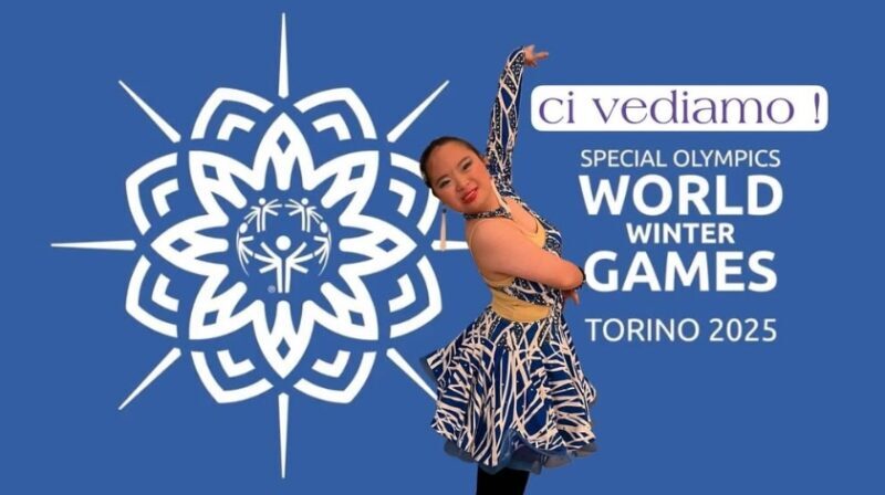 Young woman striking a dance pose in front of World Winter Games Torino 2025 signage.