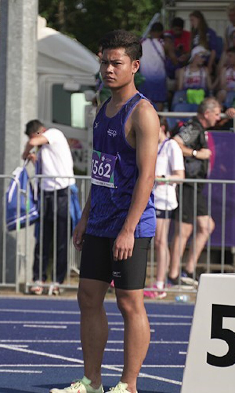 Young man standing on the racetrack. 