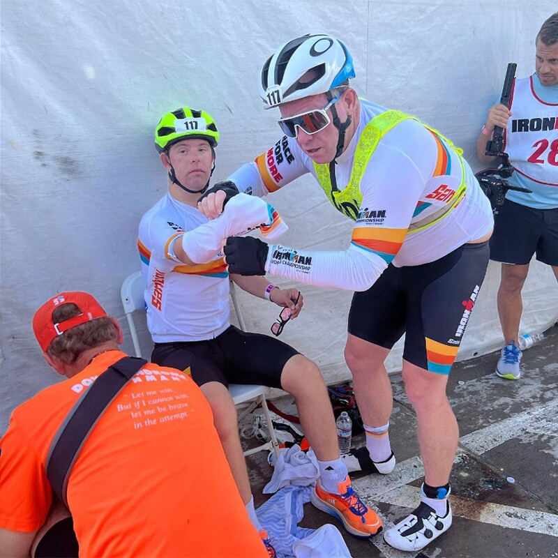 Two men work together.