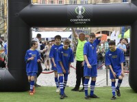 A group of young footballers entering a pitch