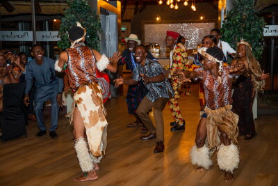 Participants and guests take part in a cultural dance performance during a community celebration event.